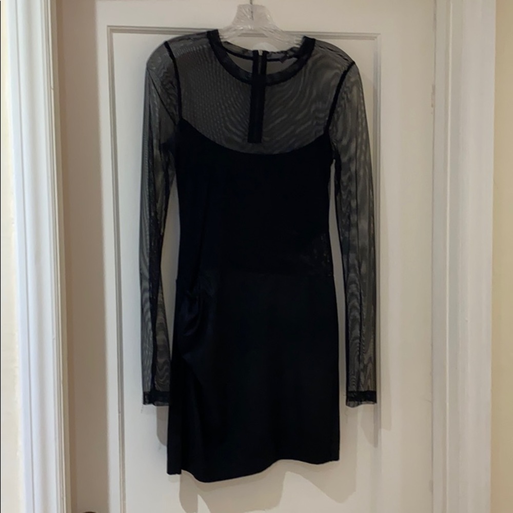 Long sleeved, black dress with angular cut out